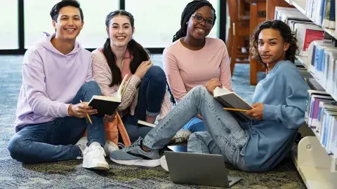 Teens studying in the library