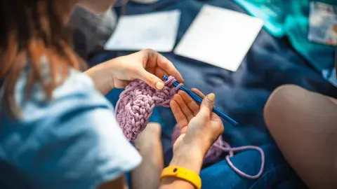 Close up of a woman crocheting