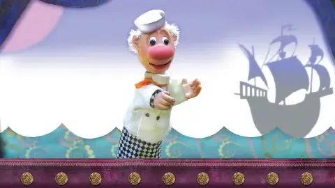 sailor puppet with a ship in the background