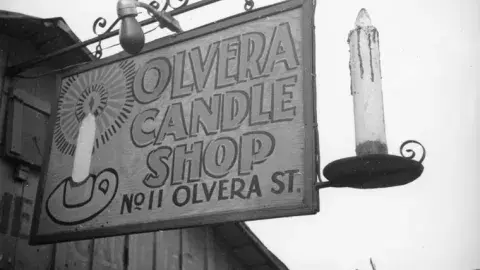 "Olvera Candle Shop" store sign.