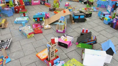 A colorful cardboard city made from recycled boxes 
