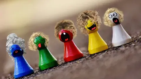 A color photo of multicolored game pieces with hair and faces, Image by Alexas_Fotos from Pixabay