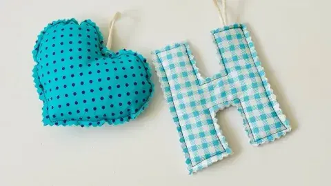 heart shape blue with black polka dots and letter H with blue and white checker pattern both made of  fabric 