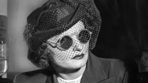 Brenda Allen wearing sunglasses and hat.