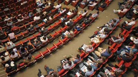 A color photo of a group of people sitting in an auditorium, Image by 정훈 김 from Pixabay