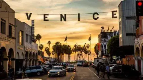 Venice Beach sign against a sunset