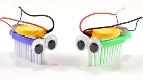  2 Bristlebots face each other, tiny robots built on the head of a toothbrush!