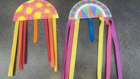 Homemade Guatemalan kites made out of paper plates, tissue paper, and craft sticks.