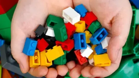 Cupped hands holding Legos