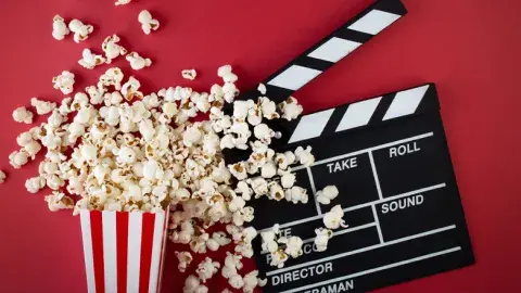 Popcorn spread out and a clapperboard.