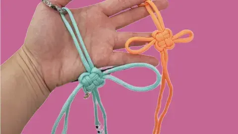a hand displaying two traditional korean knots 