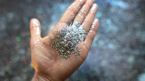 Hand holding colorful glitter