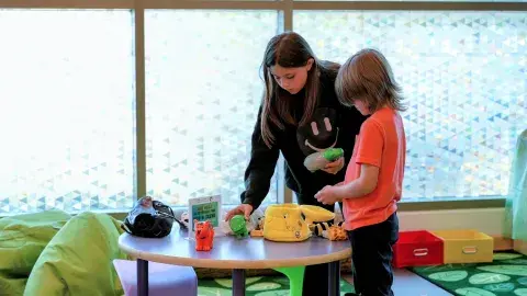 two children interact with activities in sensory-friendly space