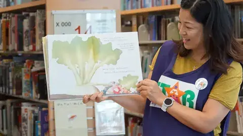 STAR reader holding picture book