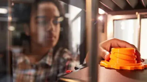 Child making a 3D printed object. 