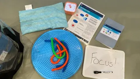 Sensory kit materials with dry erase board that reads "focus"