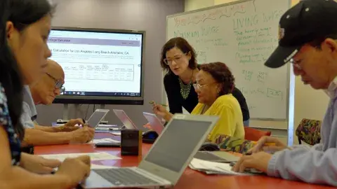 Adult learners learning in a class room setting.