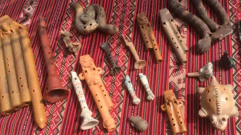 Various Native North American musical instruments on blanket