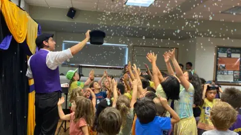Arty Loon the magician putting on a show for children.