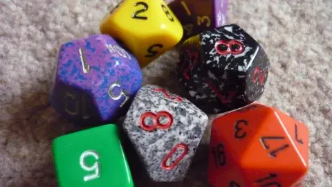 Green, purple, yellow, red, gray, and black dice.