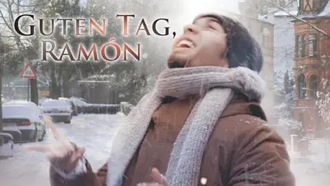 A person in winter clothing stands outside in a snowy city, looking up and smiling. Text on the image reads “Guten Tag, Ramón.”.