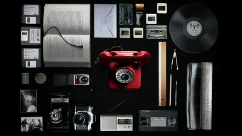 Different types of analog film and video items with a black background.
