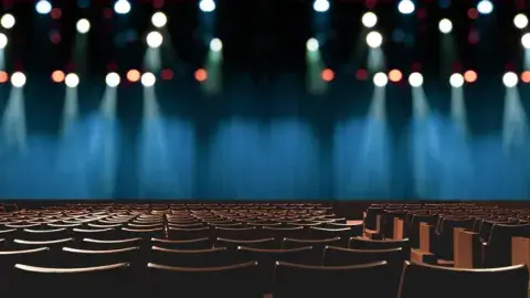 empty auditorium with lights and chairs