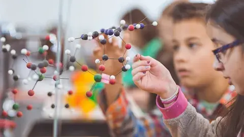 Children with a molecule model