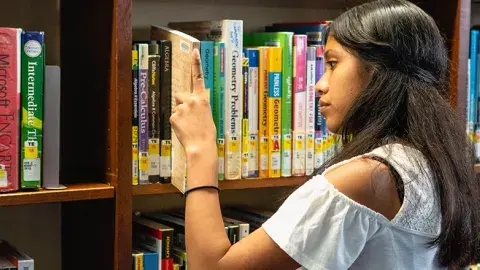 volunteer using the library