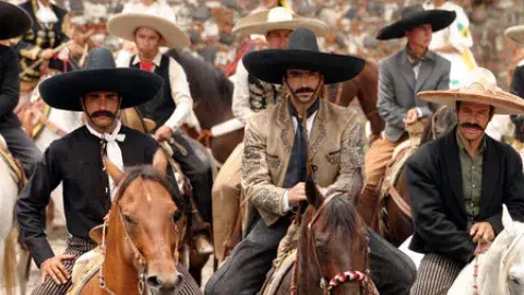 men with cowboy hats on horses