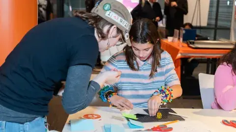 2 teens crafting at a library event