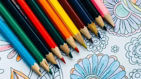 Assortment of colored pencils with a coloring sheet