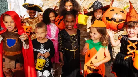 Children in colorful Halloween costumes. 