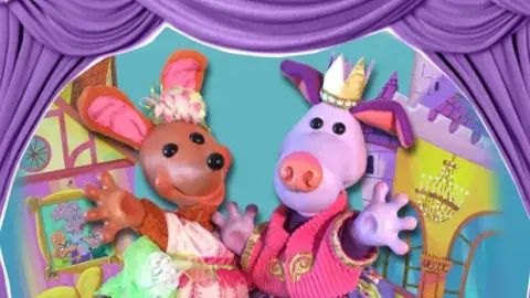 Two colorful animal puppets waving