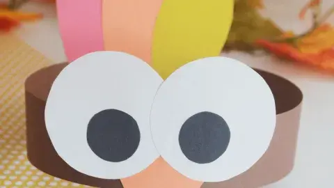 A turkey with big eyes made out of paper.