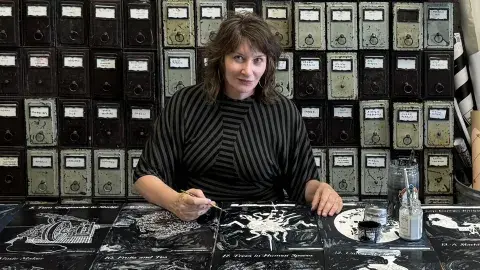 Artist Ellen Harvey painting