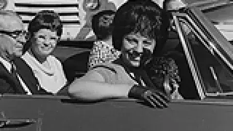 vintage b&w photo of ladies in a car with a sign that read La Donna Harris, Indian of the year