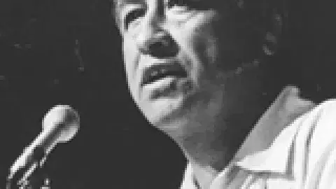 Cesar Chavez speaking into a microphone