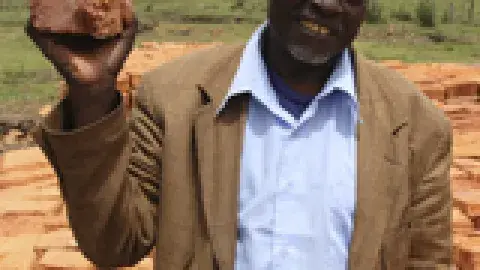 man holding up a Clay Water Brick