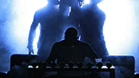 4 male dancers in shadow during a staged performance