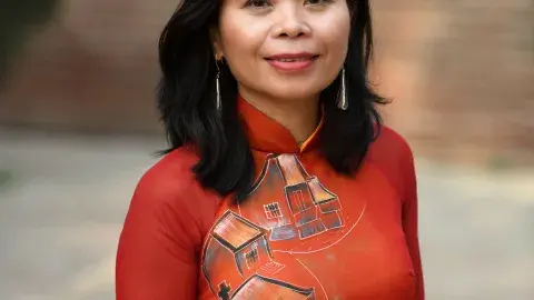 author and poet Nguyễn Phan Quế Mai in a red dress