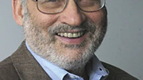 Joseph E. Stiglitz smiling and wearing glasses