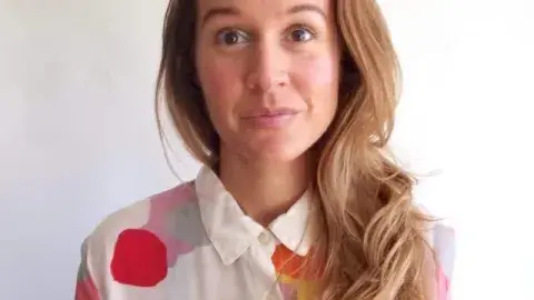 Danielle Davis in a polka dot blouse
