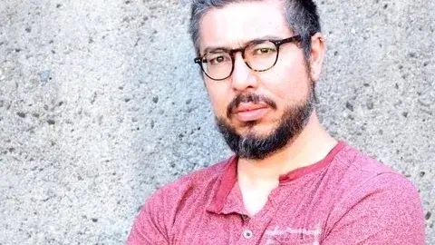 J. Michael Martinez in a rose colored t shirt
