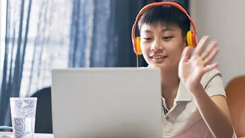 student with a laptop and headphones