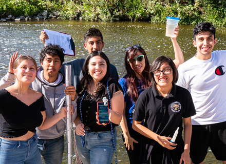 teens participating in a water transparency exercise by the LA River